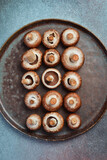 Fototapeta Mapy - Fresh champignons close-up. Top view. Rustic style.