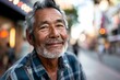 Portrait of an old Asian man with a beard in the street