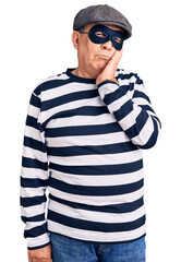 Sticker - Senior handsome man wearing burglar mask and t-shirt thinking looking tired and bored with depression problems with crossed arms.