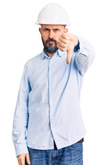 Poster - Young handsome man wearing architect hardhat looking unhappy and angry showing rejection and negative with thumbs down gesture. bad expression.