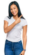 © Krakenimages.com - Beautiful hispanic woman wearing casual white tshirt cheerful with a smile on face pointing with hand and finger up to the side with happy and natural expression