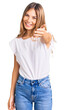 © Krakenimages.com - Beautiful caucasian woman with blonde hair wearing casual white tshirt smiling friendly offering handshake as greeting and welcoming. successful business.