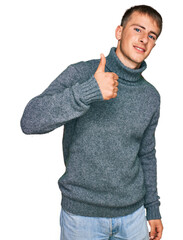 Poster - Young blond man wearing casual clothes doing happy thumbs up gesture with hand. approving expression looking at the camera showing success.