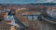Aerial panoramic cityscape of Rome, Italy. Rome's aerial view at dawn or dusk highlights an iconic bridge over the Tiber, mixing historic and modern architecture. 