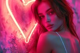Fototapeta Boho - Young woman posing with neon heart in front of pink neon lights on wall in urban setting