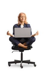 Wall Mural - Businesswoman sitting in a chair with laptop computer and meditating