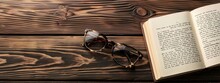 Open Notepad With Glasses On A Pine Desk
