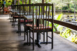 Chairs and table on the backyard in tropical cafe near lake with beautiful view