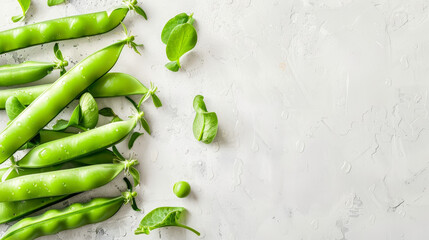 Canvas Print - Sugar snap peas with water droplets on white textured marble background.