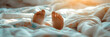 Cute feet of little sleeping child sticking out from under the blanket at sunny morning