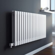 white radiator in a room with a gray wall