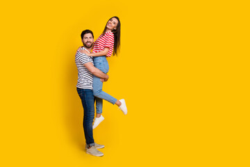 Aufkleber - Full length photo of cheerful optimistic couple boyfriend holding on hands adorable girl isolated on vivid yellow color background