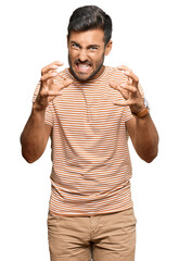 Wall Mural - Handsome hispanic man wearing casual clothes shouting frustrated with rage, hands trying to strangle, yelling mad