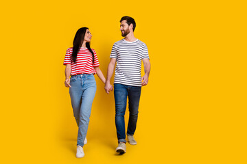 Sticker - Full size photo of couple girl guy dressed striped t-shirt look at each other walking on valentine day isolated on yellow color background