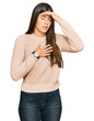 © Krakenimages.com - Young brunette woman wearing casual winter sweater touching forehead for illness and fever, flu and cold, virus sick
