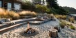 a modern seaside-inspired backyard with a sandy fire pit area