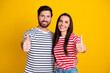 © deagreez - Photo portrait of lovely young couple hugging show thumb up wear trendy striped garment isolated on yellow color background