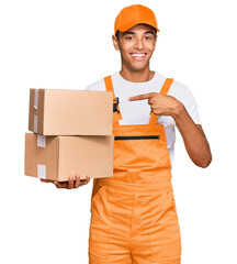 Poster - Young handsome african american man holding delivery package smiling happy pointing with hand and finger