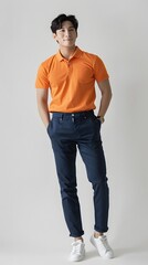 A handsome japanese man, standing, wearing an orange polo shirt, with hand in the pocket