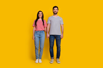 Aufkleber - Full length photo of adorable cheerful lovely couple wear striped t-shirt jeans holding hands isolated on vivid yellow color background