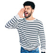 © Krakenimages.com - Young arab man with beard wearing casual striped sweater shouting and screaming loud to side with hand on mouth. communication concept.