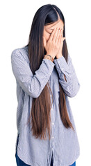 Canvas Print - Young beautiful chinese woman wearing casual shirt with sad expression covering face with hands while crying. depression concept.