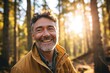 Portrait of a smiling middle-aged man in the autumn forest.
