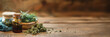 Cannabis (or hemp or marijuana) dried flower buds, bottle of CBD oil, medicinal legal cannabis web banner, natural alternative medicine on panoramic wood background