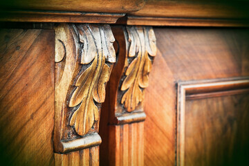 Wall Mural - Detail of an old carved italian wooden furniture with carved floral elements just restored