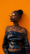 Stylish woman in sunglasses against orange background