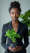 Consultant végétal, allégorie de la croissance verte et de la RSE en entreprise, manager en costume vert tenant une plante dans ses mains