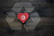 Wooden Heart With National Flag Of Tunisia Near Reduce, Reuse And Recycle Sing On The Wooden Background. Concept
