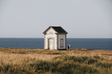 Scenic view of an old structure near the beach with a blue ocean in the background