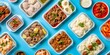 Food flatlay of Asian takeaway dishes in containers featuring rice, shrimp, and various meats, perfect for mealprep inspiration.