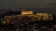 Aerial shot of Athens with the Acropolis on a rocky outcrop above the city in the evening, Greece.