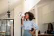 African american woman wearing blue shirt shouting loud holding a megaphone, expressing success and positive concept, idea for marketing or sales