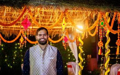 Wall Mural - Two Indian man in traditional wear or kurta pyjama cloths. Male fashion model in sherwani, posing / standing against wedding mandap background