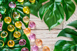 Colorful Soft Gel Pills Amidst Green Foliage