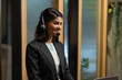 Asian indian woman call center - customer service. Attractive business Asian woman in suits and headsets working with desktop computer at telemarketing customer service agents