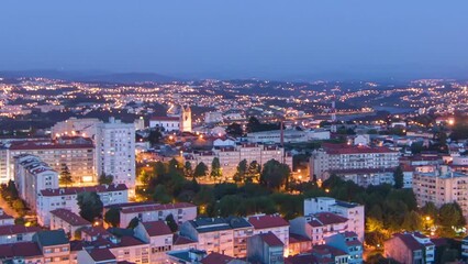 Wall Mural - Aerial view on Rooftops of Porto's old town on a warm spring evening timelapse day to night transition from above, Porto, Portugal. Lights turning on