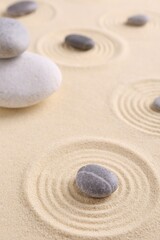 Wall Mural - Zen garden stones on sand with pattern, closeup