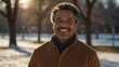 middle aged multiracial man on morning sunlight winter park background smiling happy looking at camera with copy space for banner backdrop from Generative AI