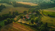 An aerial view of a tranquil countryside dotted with patchwork fields and farmhouses