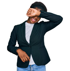 Wall Mural - Young african american girl wearing business clothes covering eyes with arm smiling cheerful and funny. blind concept.
