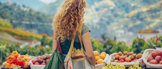 Poster - On top of a mountain, young beautiful woman with curly hair enjoys the beauty of the majestic mountains. Travel, adventure, active lifestyle concept.