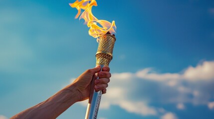 Wall Mural - person holding the olympic torch with beautiful blue sky background in high resolution and quality