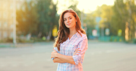 Wall Mural - Portrait beautiful happy smiling brunette young woman posing in the city