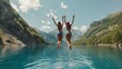 Two young people jump together into a lake in the mountains with beautiful blue water and reflections.