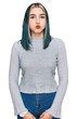 Young modern girl wearing casual sweater puffing cheeks with funny face. mouth inflated with air, crazy expression.