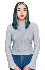 Sticker - Young modern girl wearing casual sweater puffing cheeks with funny face. mouth inflated with air, crazy expression.